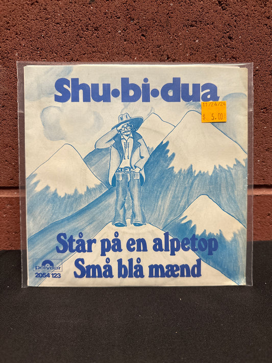 Used Vinyl:  Shu-Bi-Dua ”Står På En Alpetop / Små Blå Mænd” 7"