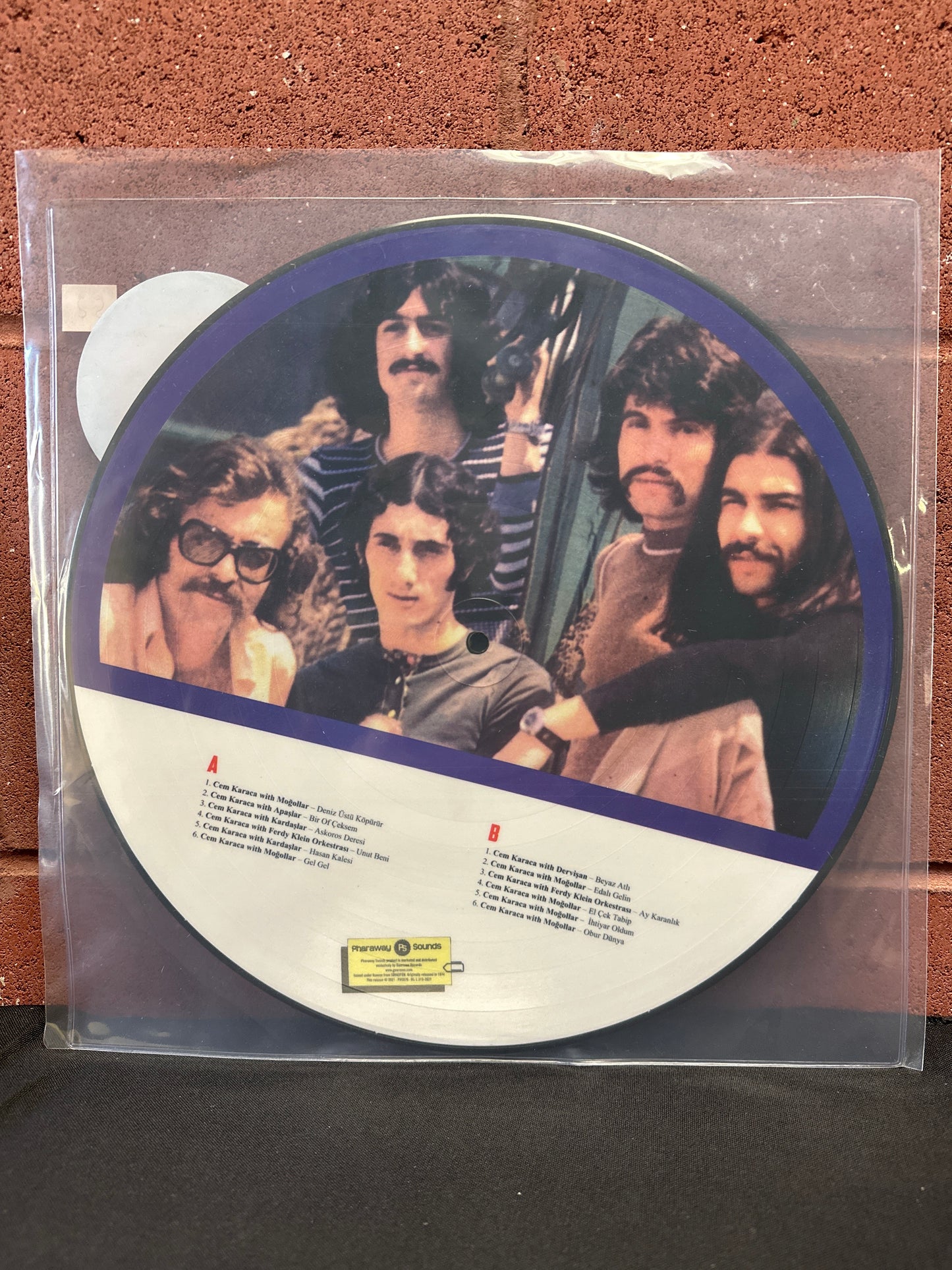 Used Vinyl:  Cem Karaca, Apaslar, KardaSlar, Mogollar, Ferdy Klein Orkestrasi ”Cem Karaca'nin Apaslar, Kardaslar, Mogollar Ve Ferdy Klein'a Tesekkurleriyle” LP (Picture Disc)