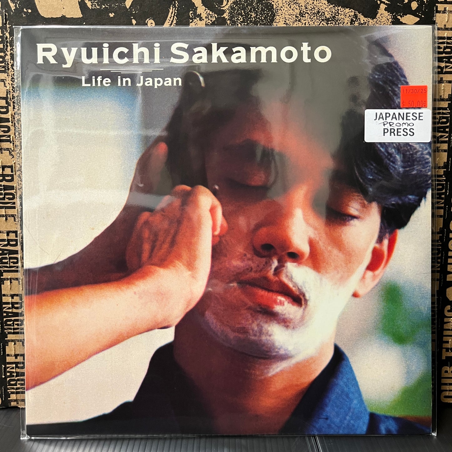 Used Vinyl: Ryuichi Sakamoto "Life In Japan" 12" (1982 Japanese Promo, Translucent Black Vinyl)