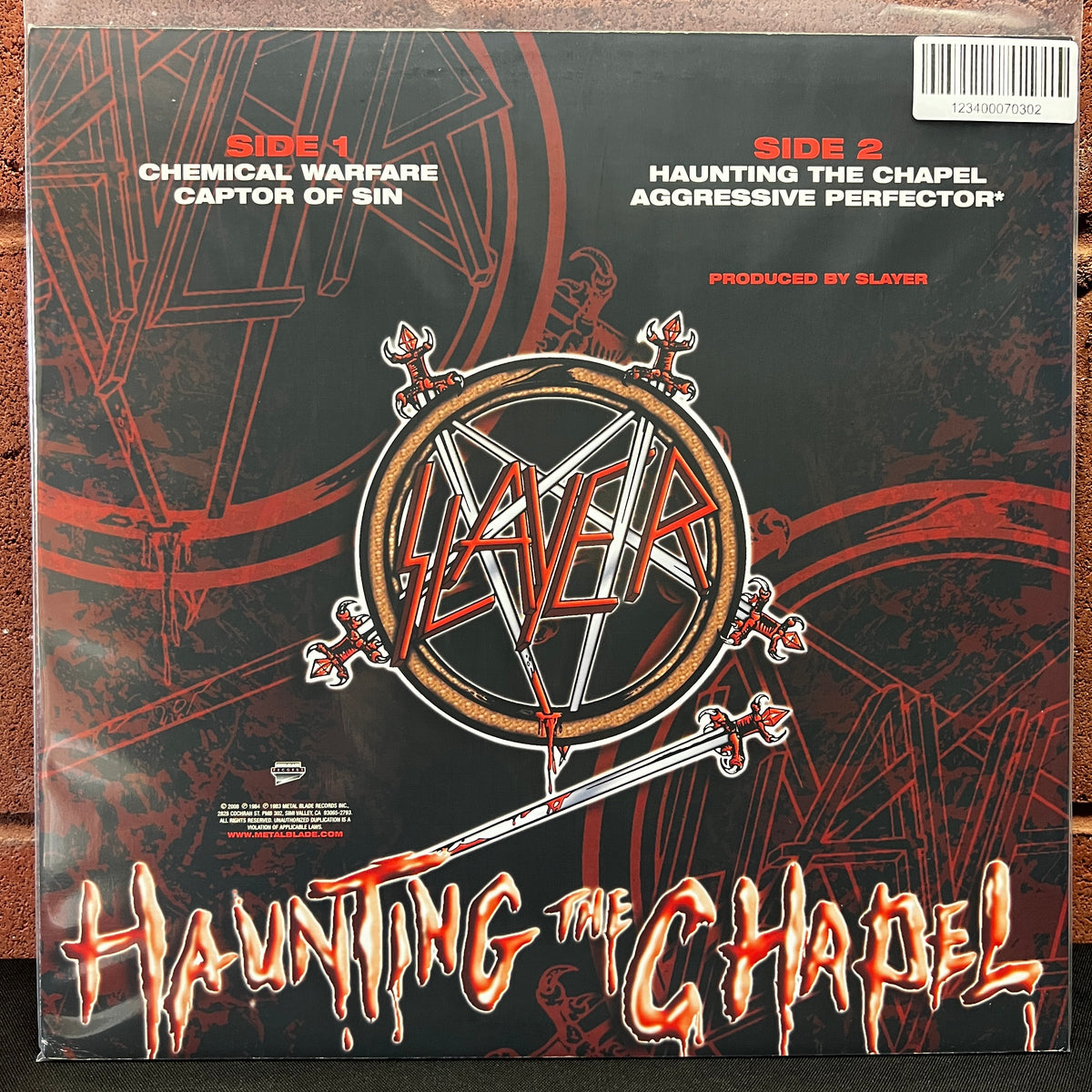 Used Vinyl: Slayer ‎"Haunting The Chapel" 12" (2008 Press - Clear w/Red Splatter Vinyl)